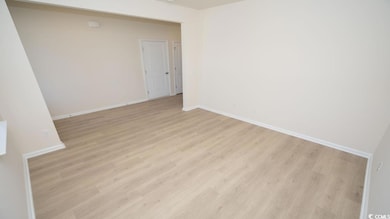Unfurnished room featuring light wood finished flo