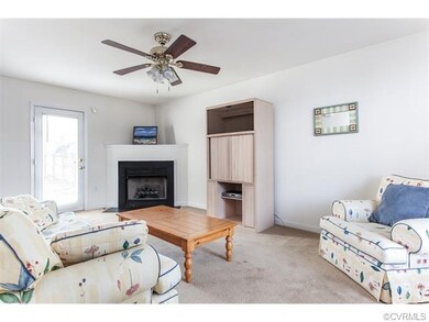 Cozy living room with ceiling fan.