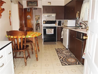 The eat in kitchen has plenty of cupboards. There 