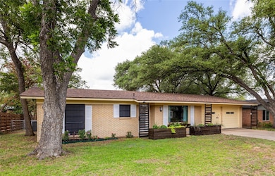 View of front of house with brick siding, drivewa