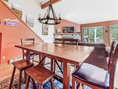 Dining area featuring wood finished floors, a chan