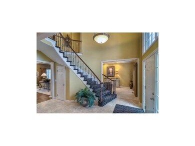 TWO STORY ENTRY, IRON SPINDLES, DESIGNER CARPET