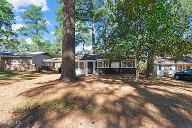 Single story home featuring a carport