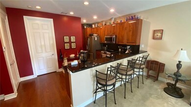 The kitchen features a snack bar with room for 3-4