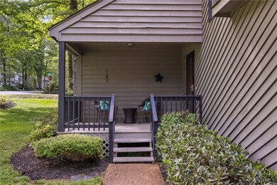 Doorway to property featuring a deck and a lawn