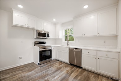 Kitchen featuring stainless steel appliances, a si