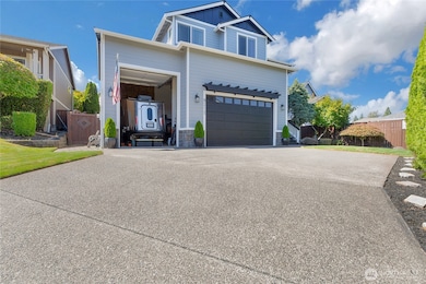 Oversized 3 car garage w/20ft ceilings. 3rd Bay has brand new 12 ft door, 22 ft deep... perfect for a 20 ft trailer or mechanics dream! Plus, extra storage area in garage.