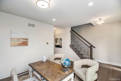 Office area featuring dark wood-style flooring and recessed lighting