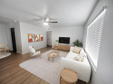 Living area featuring wood finished floors and a ceiling fan