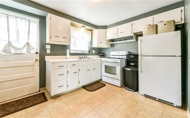 White kitchen with side door that steps out to the