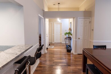 Hall featuring dark wood finished floors, visible 