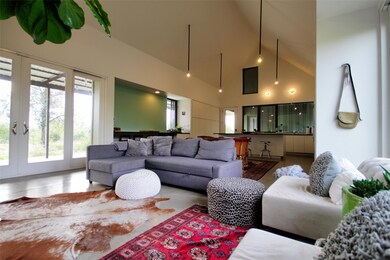 Living room featuring high vaulted ceiling and fr