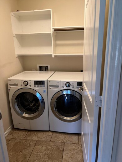 Washroom featuring washing machine and dryer and 