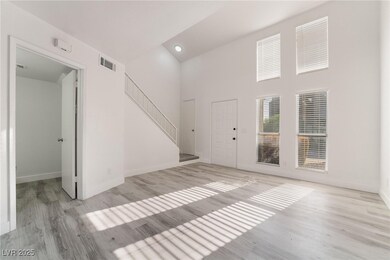 Unfurnished living room featuring a towering ceili