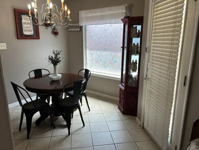 Tiled dining room with a notable chandelier
