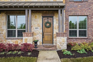 Entrance to property featuring stone siding and br