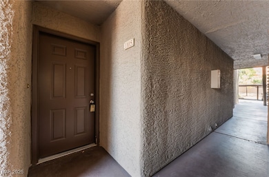 Doorway to property featuring stucco siding