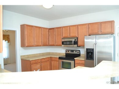 Kitchen with bar, stainless appliances and pantry