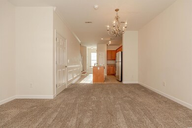 Empty room with light carpet, baseboards, visible 