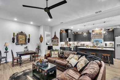 Living room featuring light wood-style floors, recessed lighting, and a ceiling fan