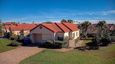Mediterranean / spanish home featuring stucco siding, an attached garage, decorative driveway, a chimney, and a tile roof
