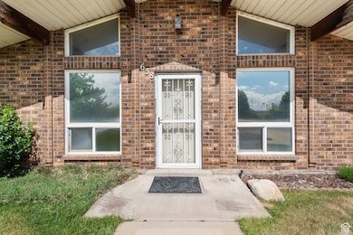 Property entrance featuring brick siding