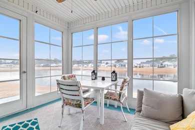 Screened in porch ith a water view and ceiling fan