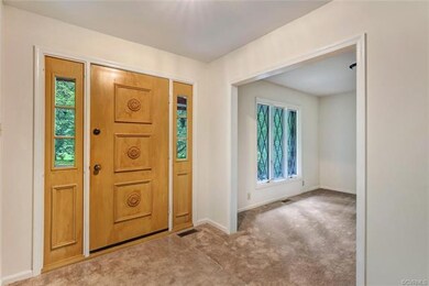 Foyer and formal dining room with new carpet, fres