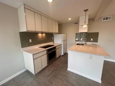 Kitchen featuring oven, black electric cooktop, f
