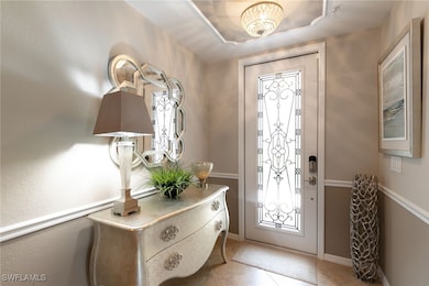 Entrance foyer featuring light tile patterned floo