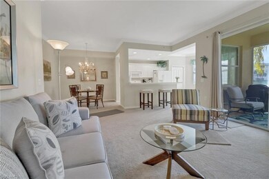 Carpeted living room featuring crown molding