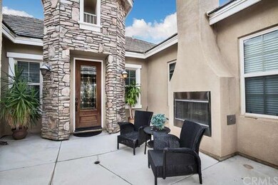private gated courtyard with an outdoor fire place