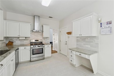 Kitchen with stainless steel appliances, wall chim