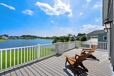 Wooden deck with a water view and a yard