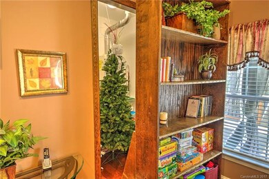 Large storage room hides behind rolling bookcase. Could easily be used as a safe room