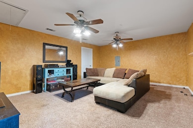 Living room with visible vents, baseboards, carpet