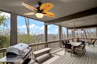 Sunroom featuring a wooden deck, hardwood / wood-style flooring, and expansive windows