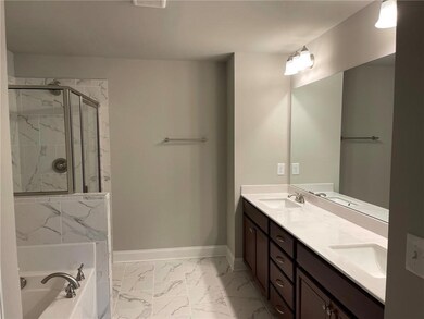Full bath featuring marble finish floor, a sink, b
