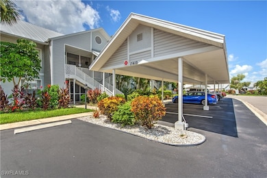 View of property featuring stairway and covered an