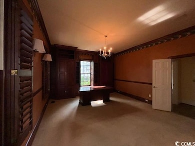 Game room with light carpet and a chandelier