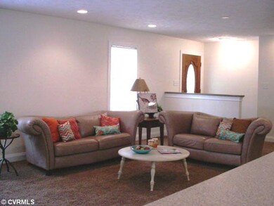 Exterior Front - A large living room with a fireplace, TV niche, and open floor plan that allows viewing from the kitchen, dining room, and living room offers everyone an opportunity to join in the fun.