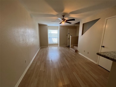 Spacious living room with ceiling fan