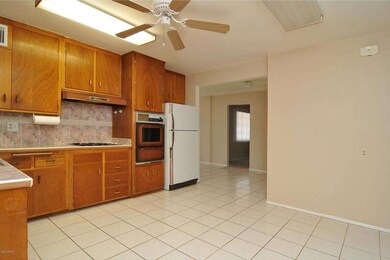 Kitchen with wall oven and refrigerator.