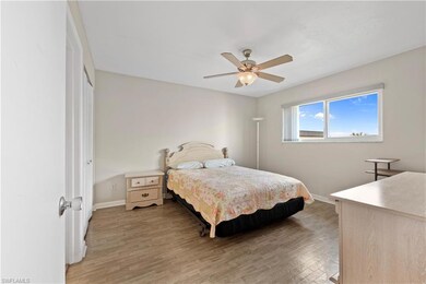 Bedroom featuring a ceiling fan, light wood-style 