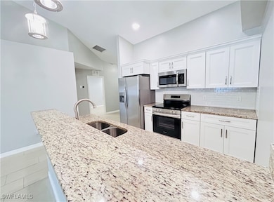 Kitchen featuring tasteful backsplash, visible ven