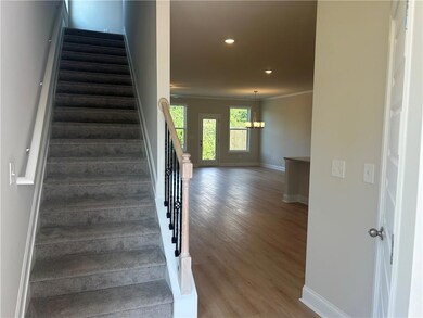 Stairway featuring wood finished floors, recessed lighting, and crown molding