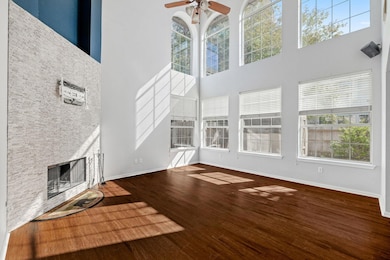 Unfurnished living room with a stone fireplace, d