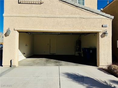 Garage with water heater and driveway