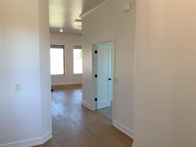Hall with ornamental molding and light hardwood / 