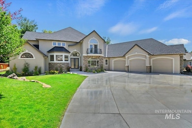 View of front of house featuring stucco siding, stone siding, an attached garage, a front yard, and driveway